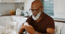 Man looking at a medication bottle